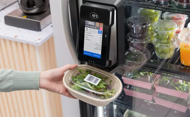 person scanning salad on vending machine