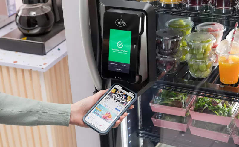 User scanning mobile app on vending machine payment terminal