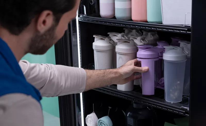 Person selecting smoothie shaker from vending machine