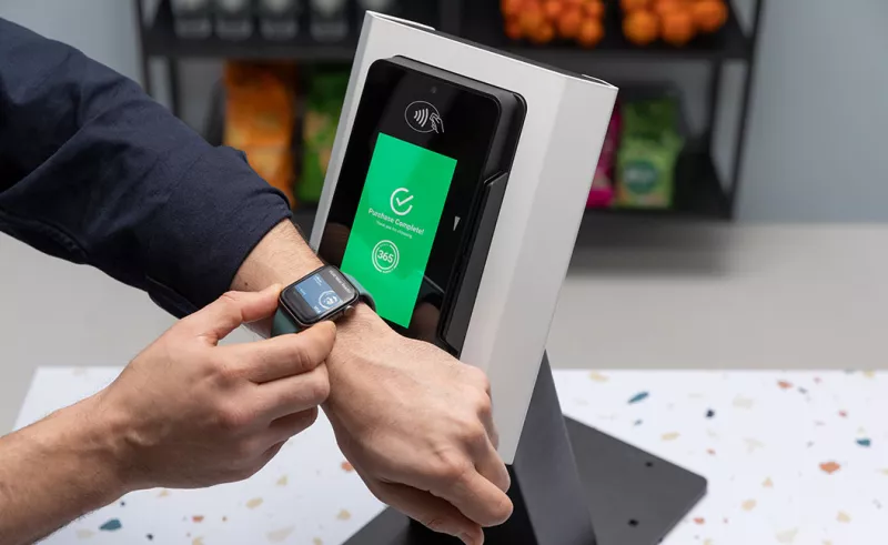 Man paying with apple watch at kiosk