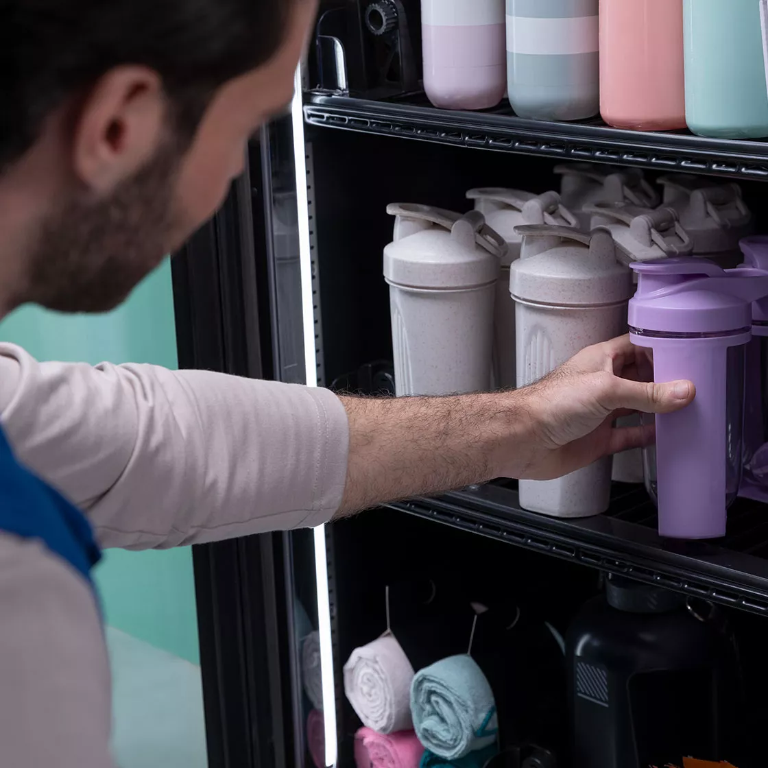 Man selecting waterbottle from vending machine 