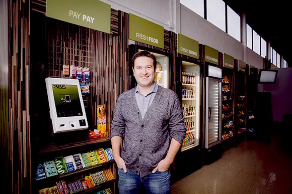 Cheerful man standing at pay pay station