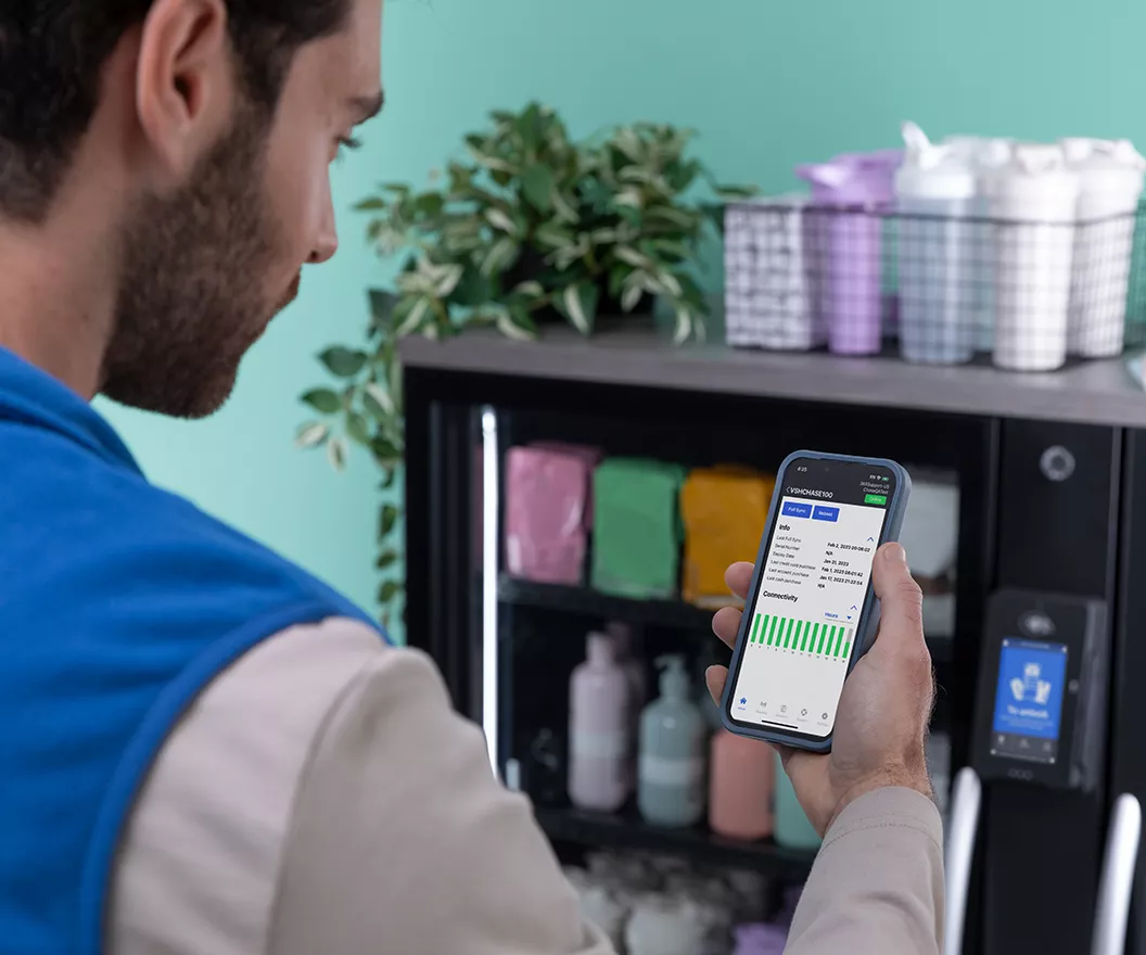 Operator looking at vending machine data on iPhone