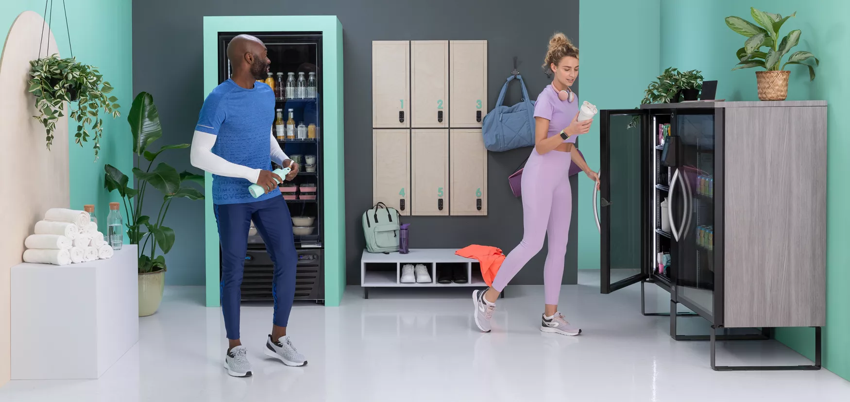 People in the gym purchssing products from vending machine