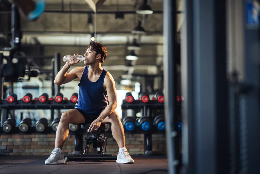 man drinking water in gym | How Smart Stores Boost Gym Revenue