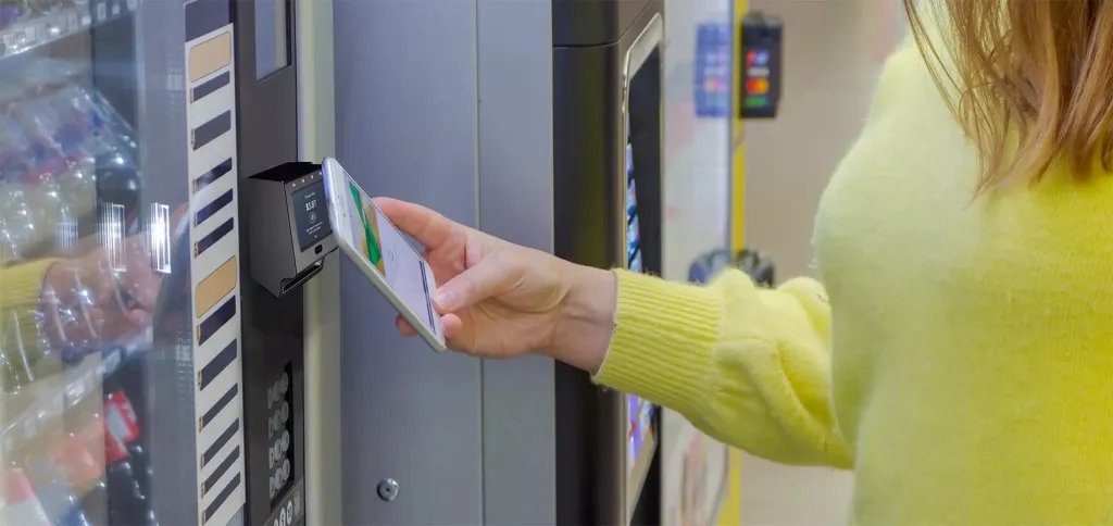 woman using PayPlus Omni | blog image | What’s the best credit card reader for vending machines? A versatile one.